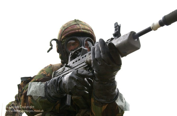 Soldier wearing butyl chemical protection gloves
